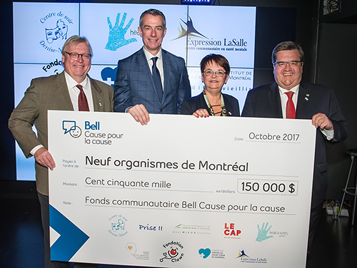 four people holding a 150,000 dollar cheque